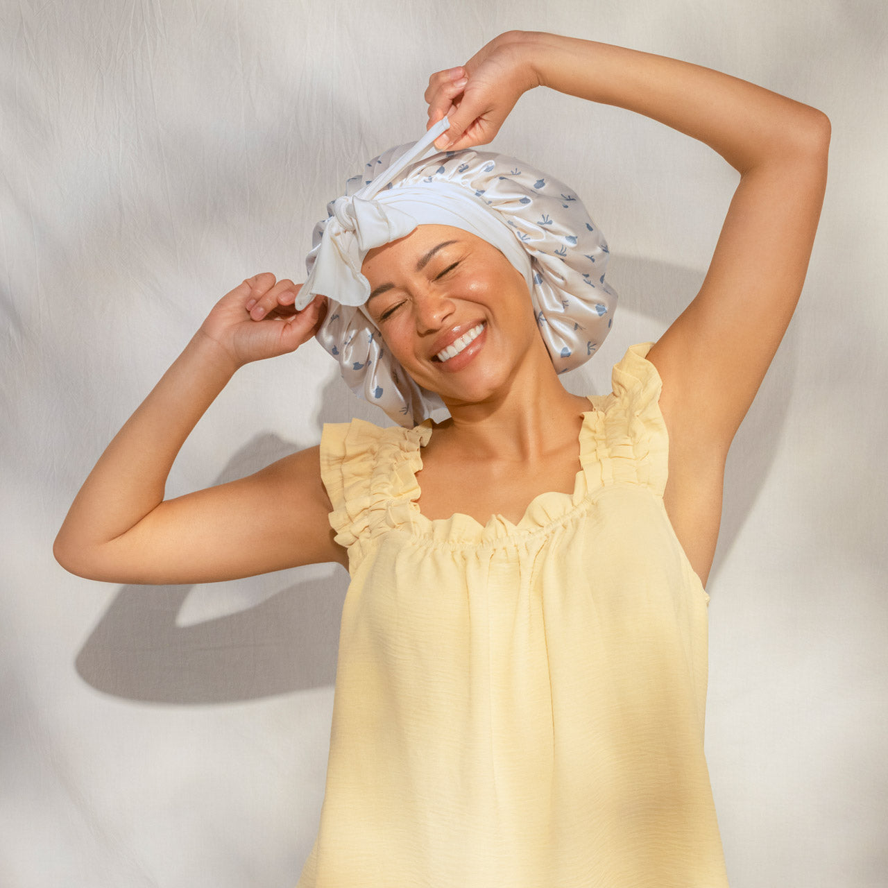 509518-CoastalCottage-OversizedSatinBonnet-PearlizedCream_CoastalBlue-Model-2-1280x1280px-1.jpg